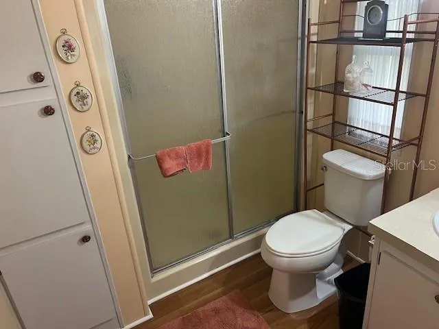 a bathroom with a toilet and a shower