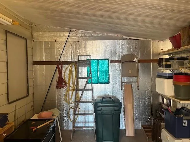 a room with furniture a air conditioner vent and white walls