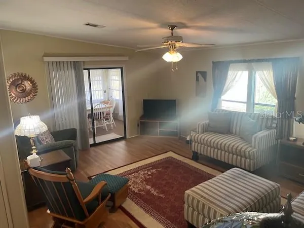 a living room with furniture and wooden floor