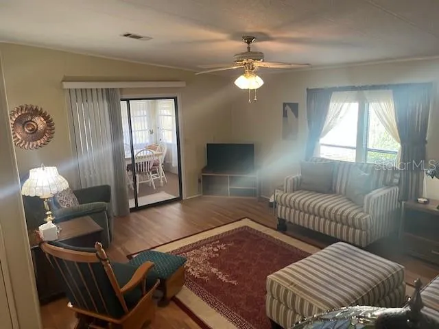a living room with furniture and wooden floor