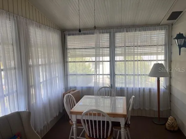 a dining room with furniture and window