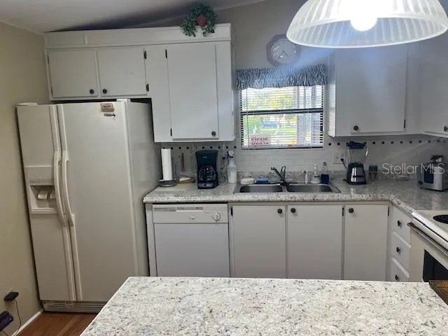 a kitchen with stainless steel appliances a refrigerator sink and cabinets