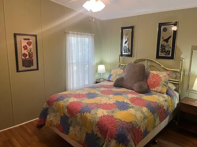 a bedroom with a bed and wall painting