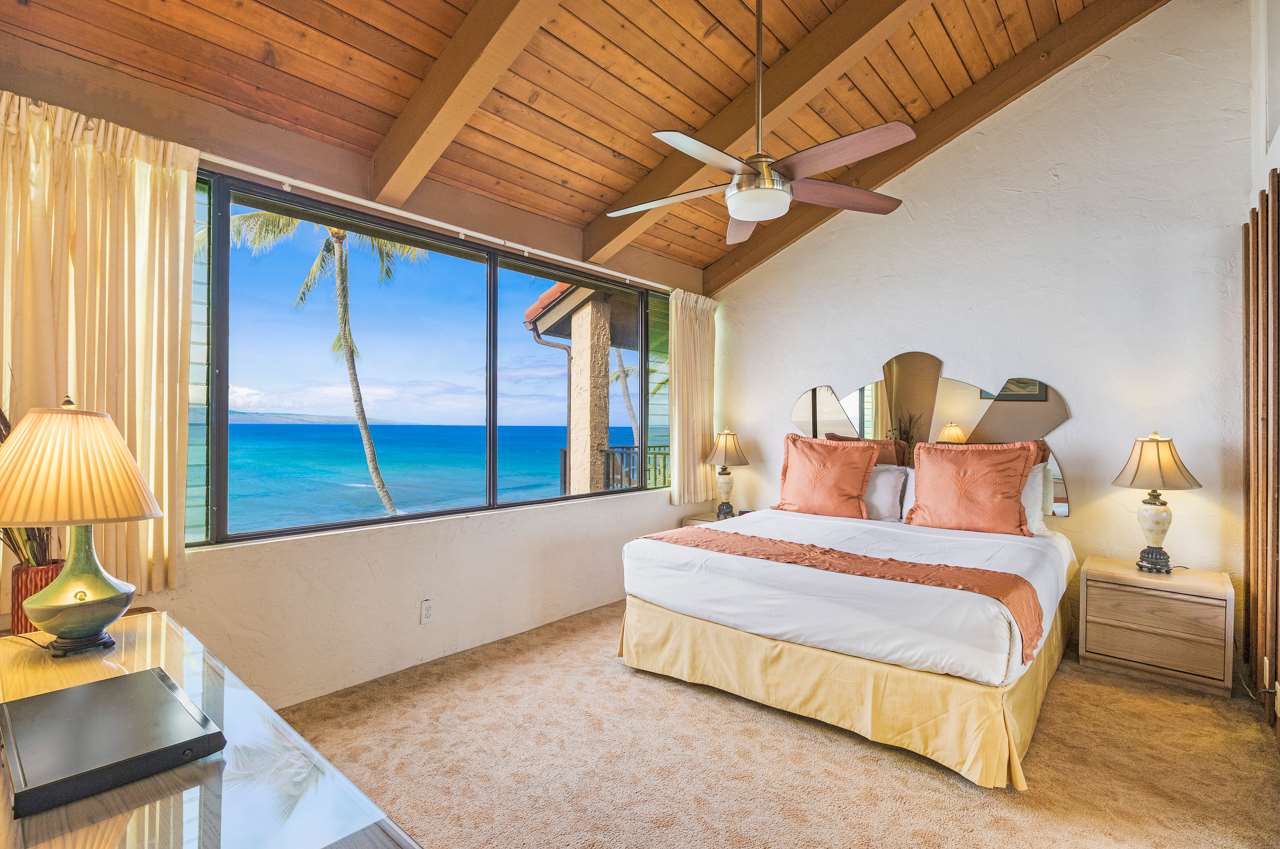 3543 Lower Honoapiilani Road, Unit F405 Lahaina, HI 96761 - Photo 11 of 30 a bedroom with a large bed and a flat tv screen on dresser