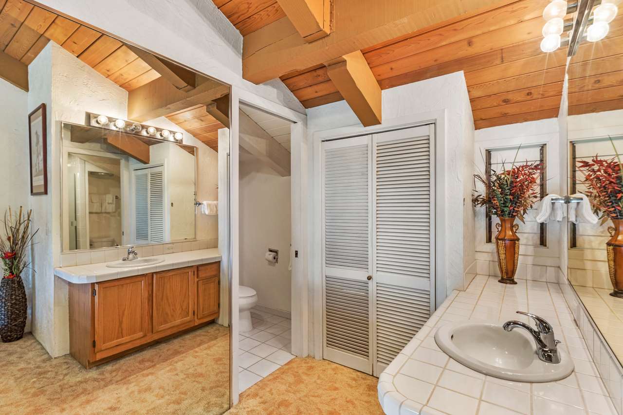 3543 Lower Honoapiilani Road, Unit F405 Lahaina, HI 96761 - Photo 28 of 30 a bathroom with a sink a mirror and shower