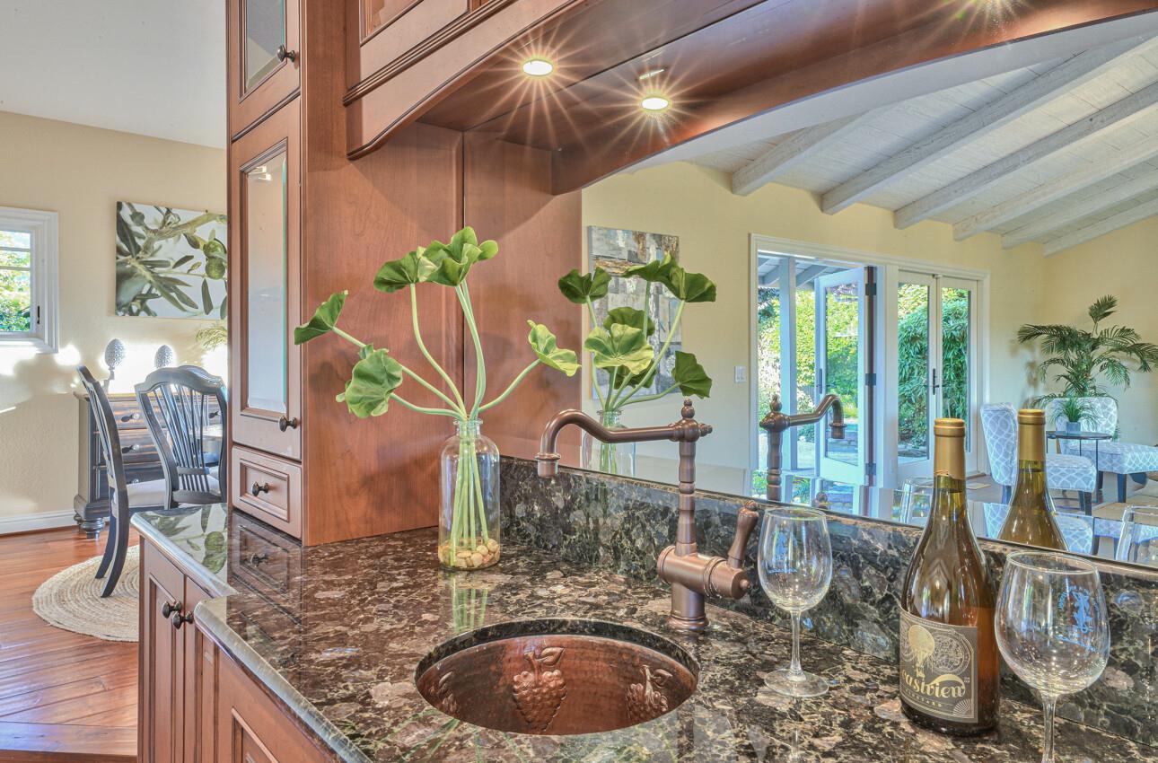 8022 River Place Carmel, CA 93923 - Photo 13 of 39 a dining room with furniture a potted plant and wooden floor