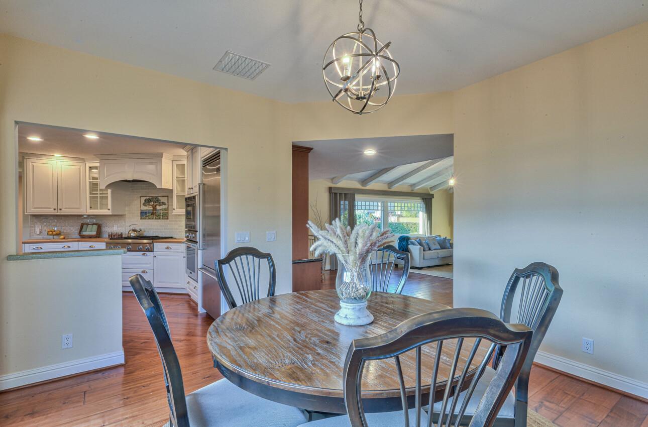 8022 River Place Carmel, CA 93923 - Photo 16 of 39 a view of a dining room with furniture wooden floor and chandelier