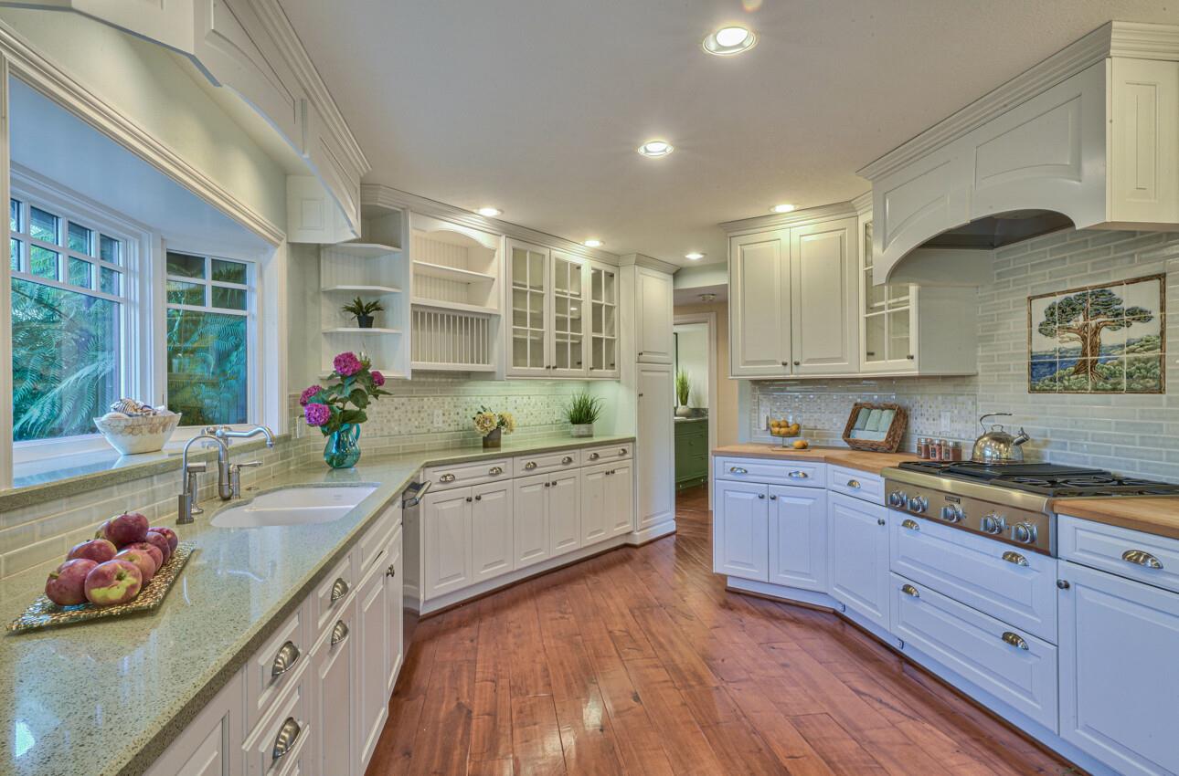8022 River Place Carmel, CA 93923 - Photo 17 of 39 a large kitchen with a lot of counter space and wooden floor
