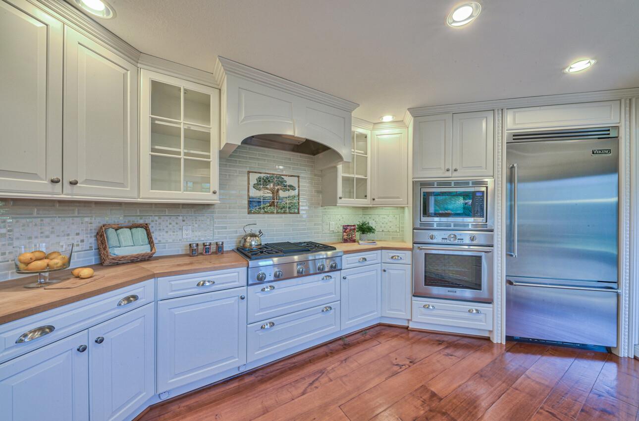 8022 River Place Carmel, CA 93923 - Photo 19 of 39 a kitchen with granite countertop white cabinets and stainless steel appliances