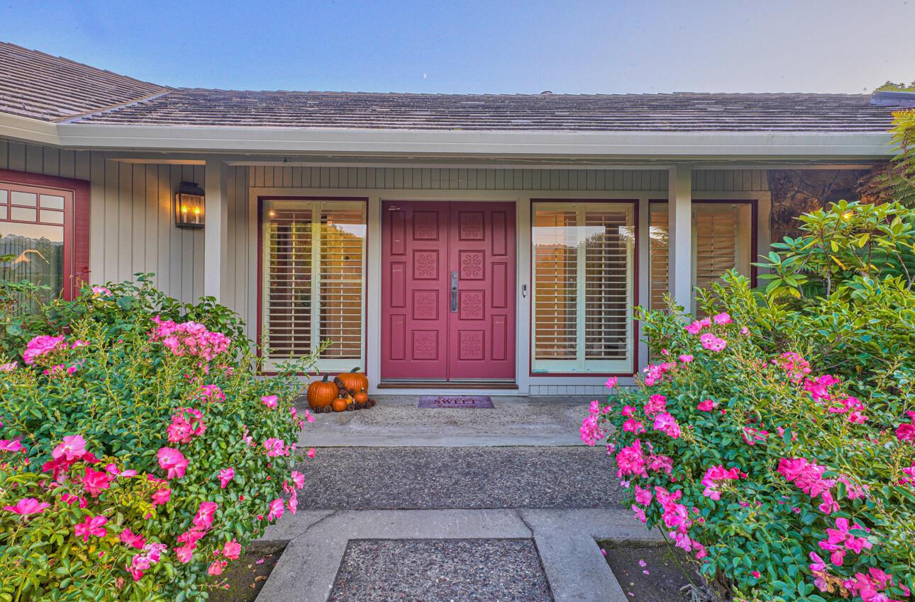 8022 River Place Carmel, CA 93923 - Photo 2 of 39 a flower garden in front of a house