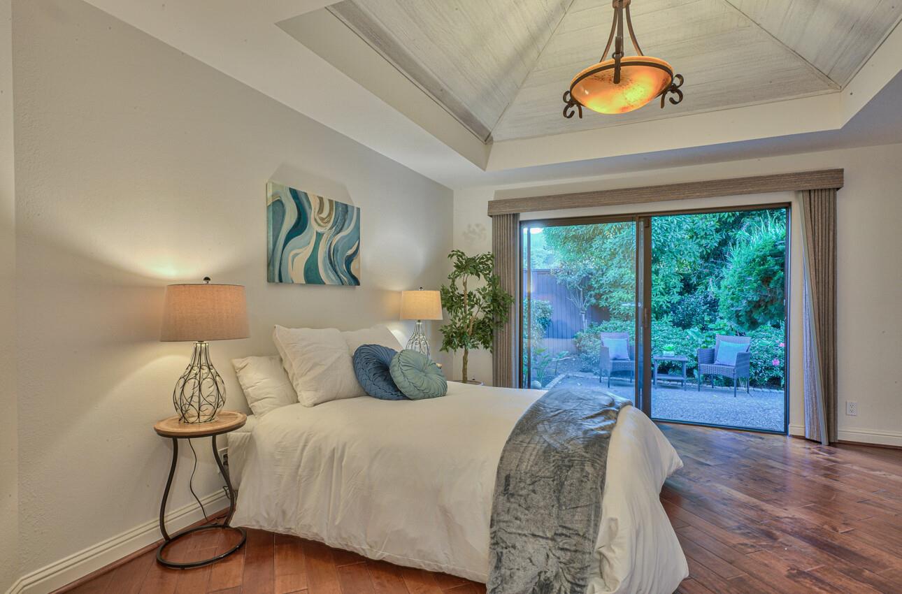 8022 River Place Carmel, CA 93923 - Photo 23 of 39 a bed sitting in a bedroom next to a window