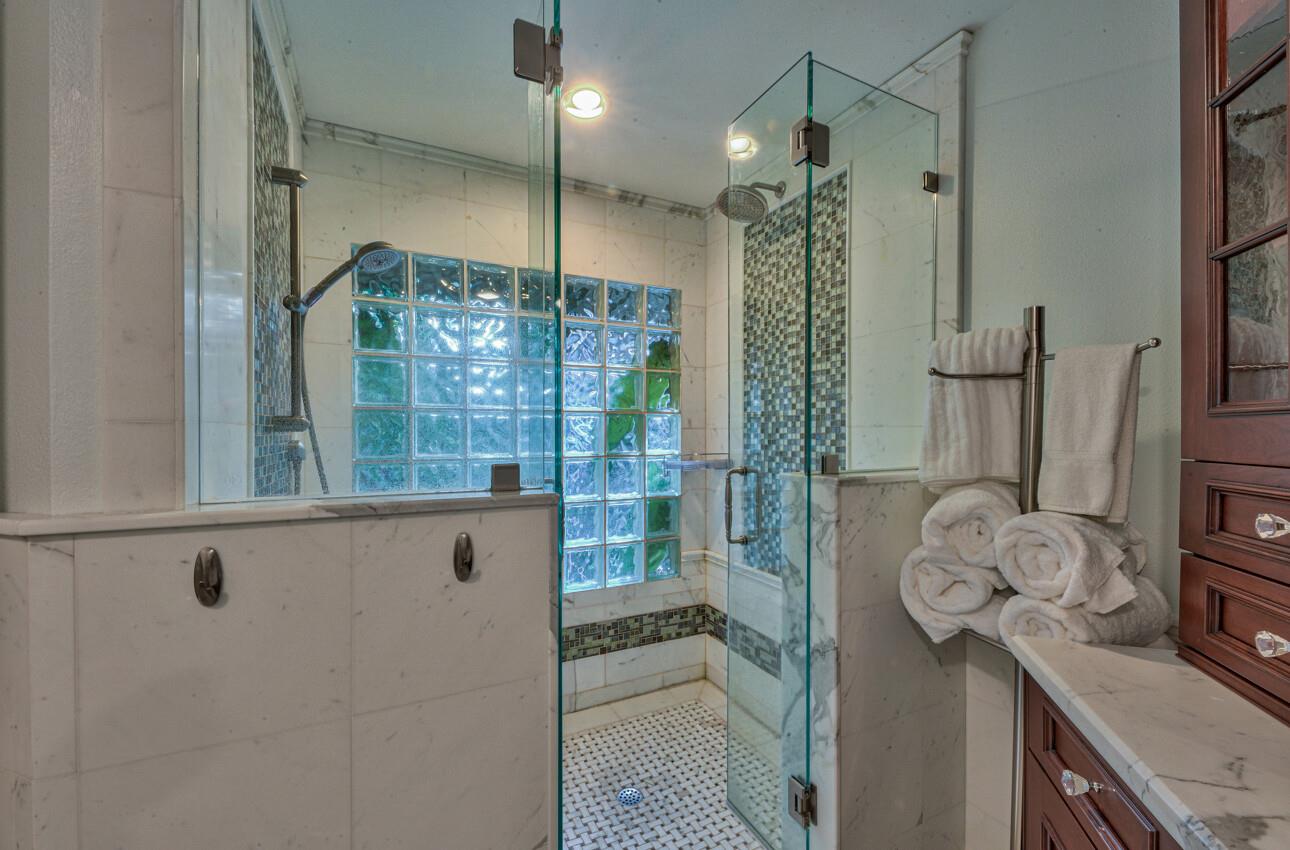 8022 River Place Carmel, CA 93923 - Photo 27 of 39 a bathroom with a shower and a sink