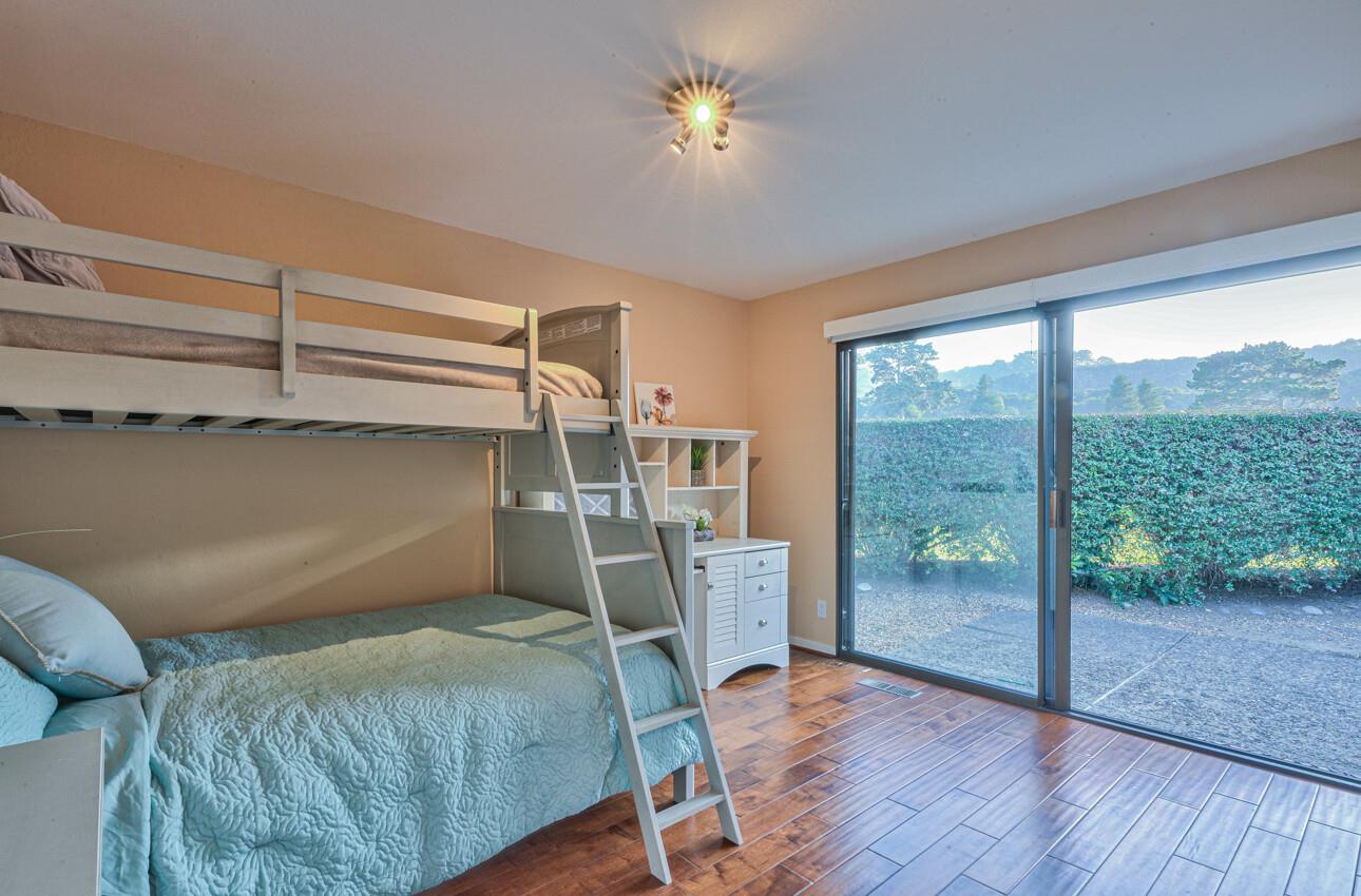 8022 River Place Carmel, CA 93923 - Photo 31 of 39 a bedroom with a bunk bed and a chandelier