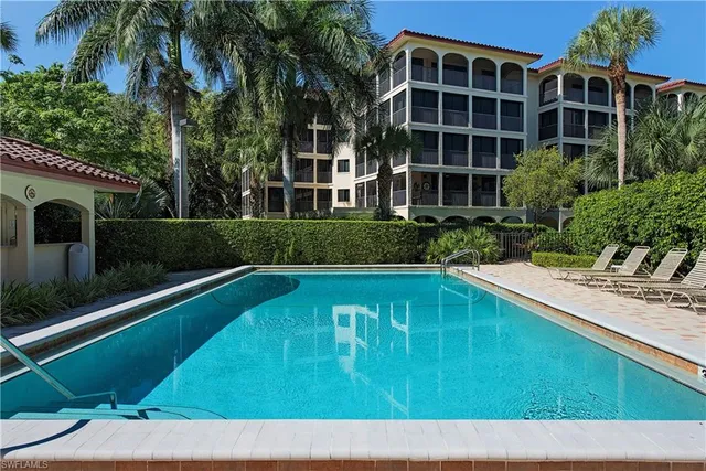 a swimming pool with outdoor seating and yard