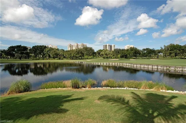 a view of a lake in front of a house with table and lake view