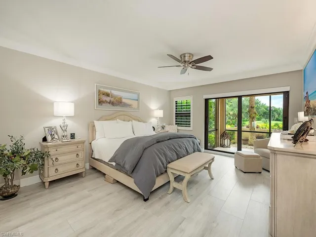 a spacious bedroom with a bed and a large window