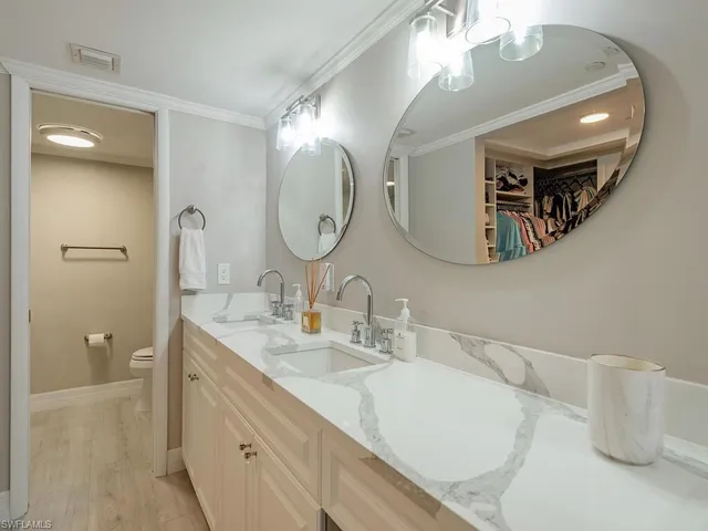 a bathroom with a double vanity sink and a mirror