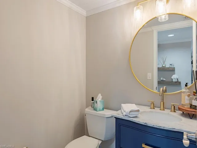 a bathroom with a granite countertop sink mirror and toilet
