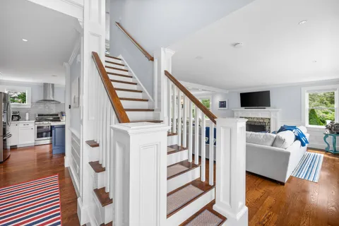 a kitchen with stainless steel appliances granite countertop a sink cabinets and wooden floor