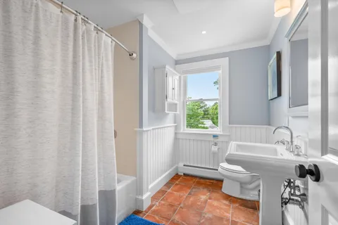 a bedroom with a large bed and a window