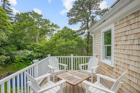 a view of deck with a large window and wooden floor