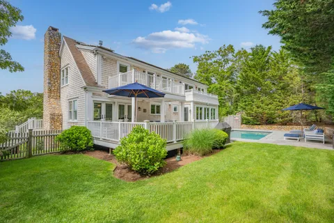 a view of a swimming pool with chairs in patio
