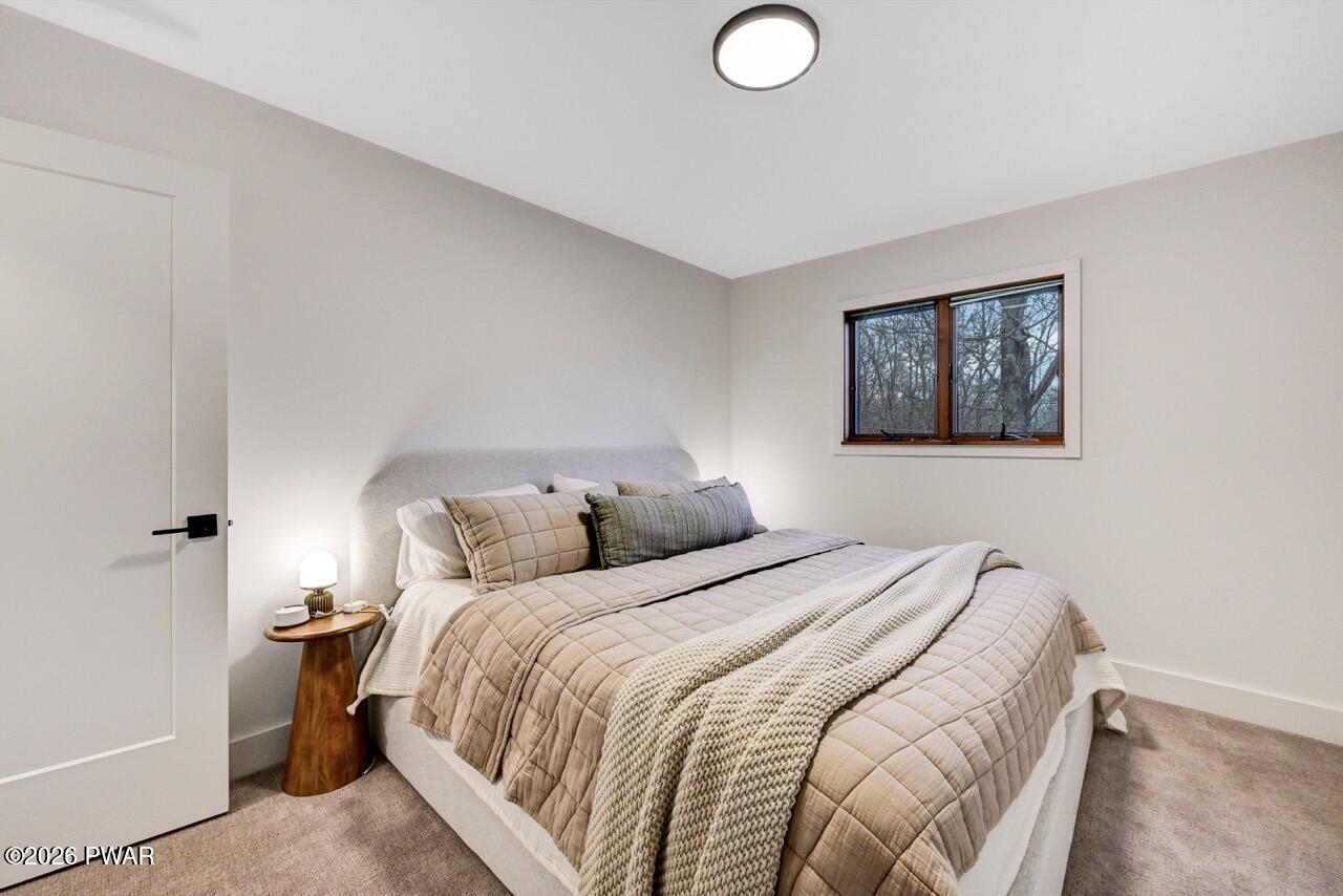 258 Lakeview Road Lackawaxen, PA 18435 - Photo 56 of 119 a bedroom with a bed and a painting on the wall