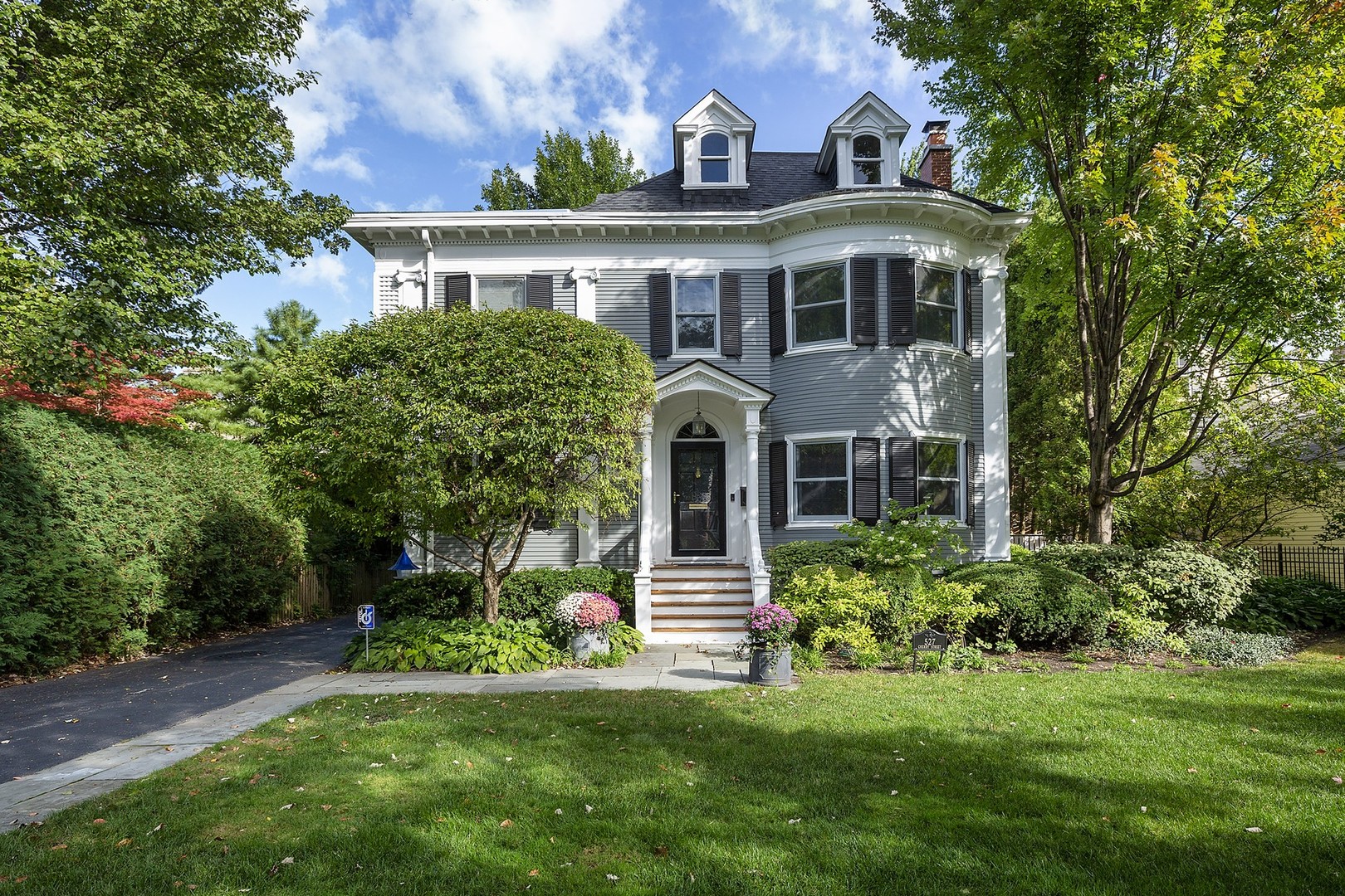 a front view of a house with a garden