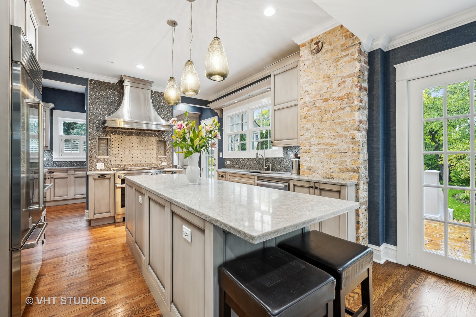 527 Cherry Street Winnetka, IL 60093 - Photo 7 of 43 a large kitchen with granite countertop a large counter top a sink stainless steel appliances and cabinets