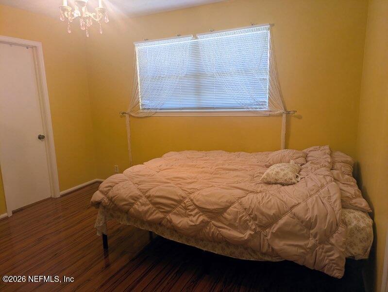 4442 River Trail Road Jacksonville, FL 32277 - Photo 19 of 38 a bedroom with a bed and wooden floor