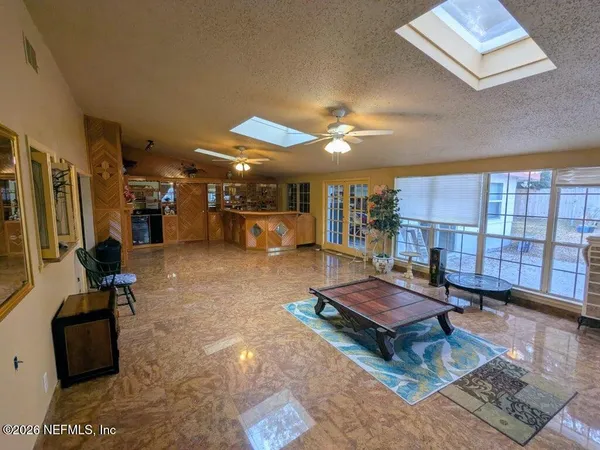 a living room with furniture gym equipment and a large window