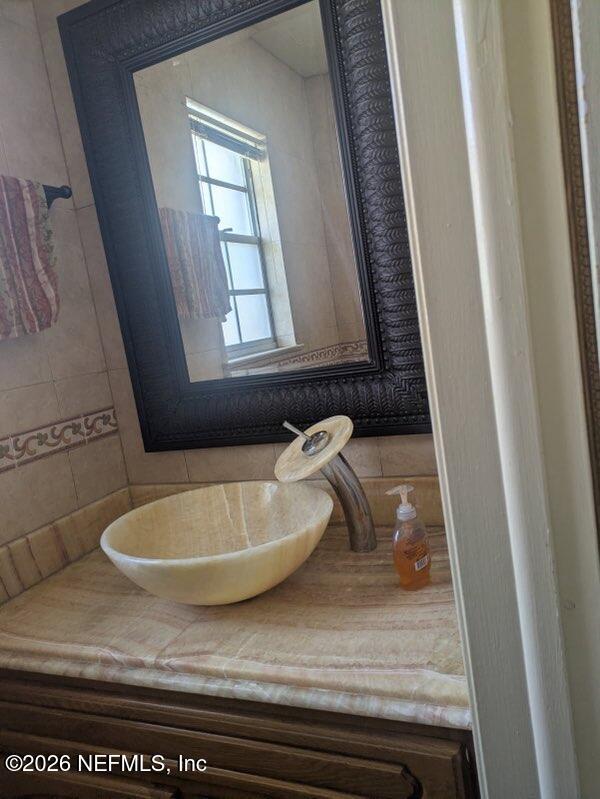 4442 River Trail Road Jacksonville, FL 32277 - Photo 21 of 38 a bathroom with a granite countertop sink and a mirror