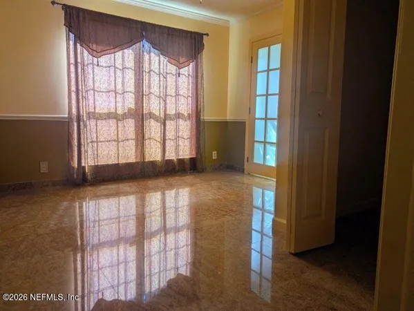 a view of a hallway with wooden door