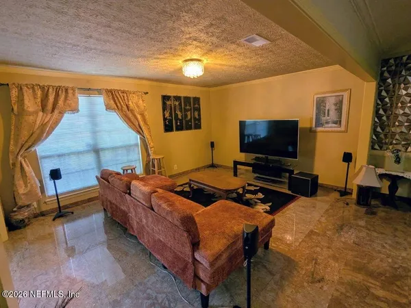 a bedroom with bed and a flat screen tv