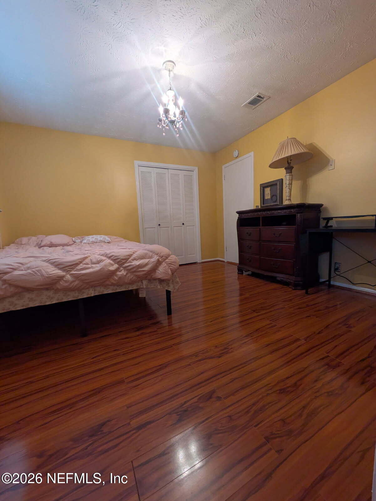 4442 River Trail Road Jacksonville, FL 32277 - Photo 34 of 38 a bedroom with a bed and wooden floor