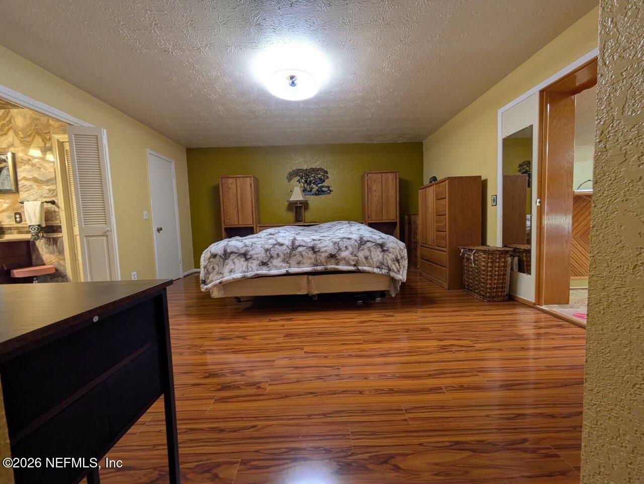 4442 River Trail Road Jacksonville, FL 32277 - Photo 38 of 38 a bedroom with a bed and wooden floor