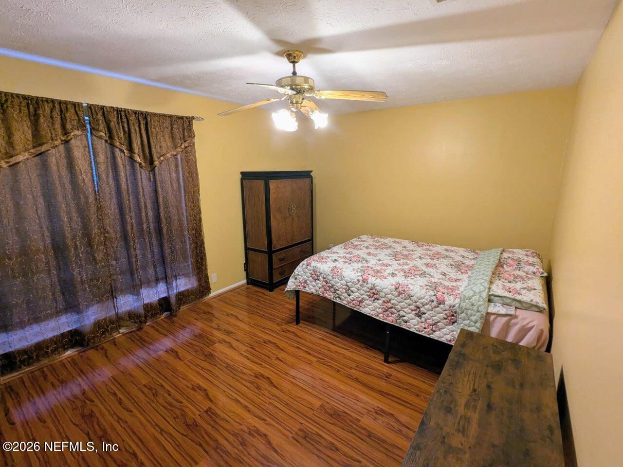 4442 River Trail Road Jacksonville, FL 32277 - Photo 4 of 38 a bedroom with a bed and a chandelier
