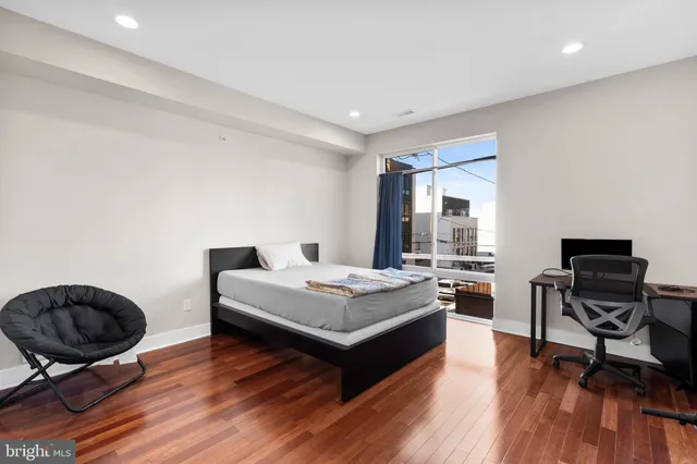 a living room with furniture a rug and a large window