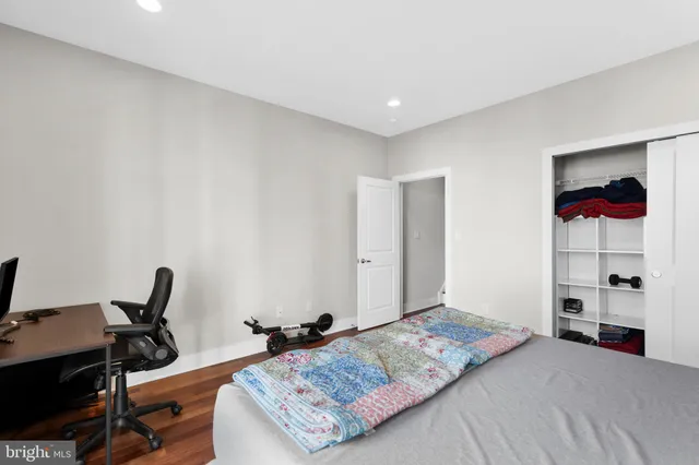 a bedroom with a bed and a desk