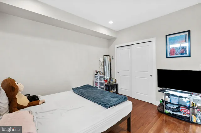 a bedroom with bed and a flat screen tv
