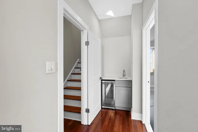 a view of hallway with stairs and wooden floor