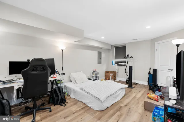 a bedroom with a bed and a computer on it