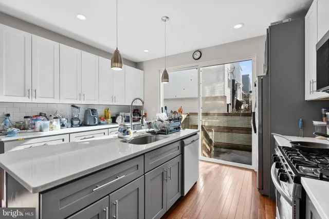 a kitchen with a sink stove and cabinets