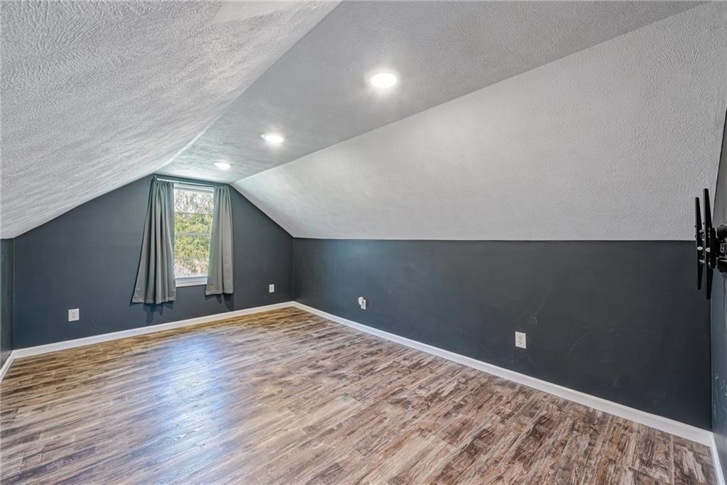 184 Glen Eden Road Rochester, PA 15074 - Photo 16 of 25 a view of an empty room with window and wooden floor