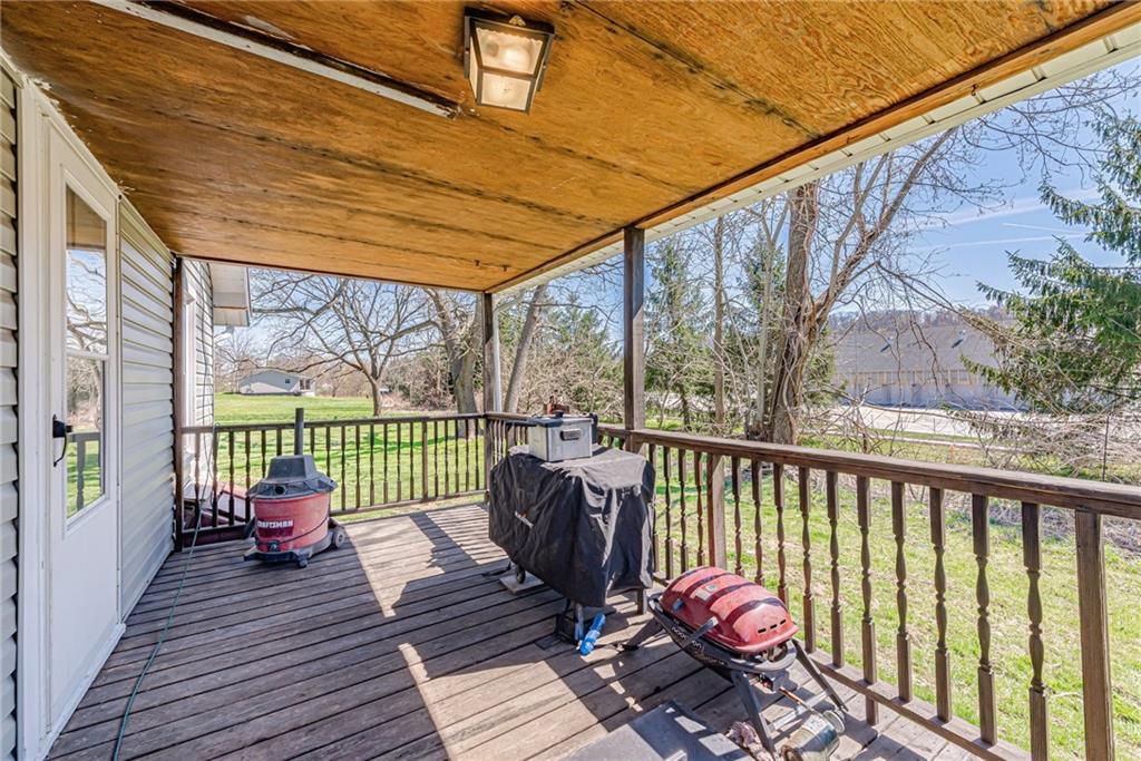 184 Glen Eden Road Rochester, PA 15074 - Photo 18 of 25 a balcony with wooden floor table and chairs