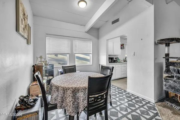a view of a dining room with furniture and a window