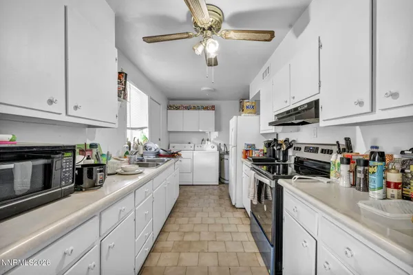 a large kitchen with stainless steel appliances granite countertop a lot of cabinets