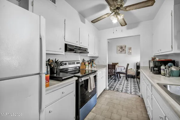 a kitchen with stainless steel appliances granite countertop a sink a stove and cabinets