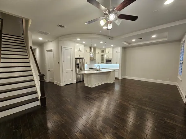 a kitchen that has a sink a stove top oven a refrigerator and a dishwasher