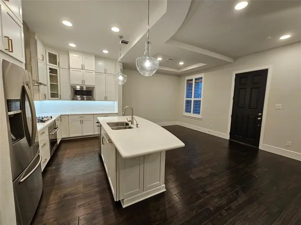 a kitchen with a sink a refrigerator and a stove